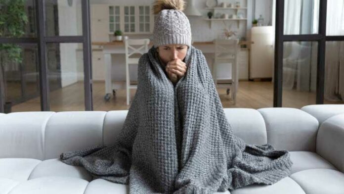 Latina female shiver at freezing flat in warm cap blanket