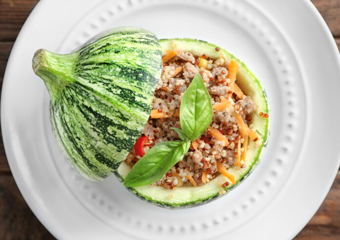 Quinoa stuffed zucchini on white plate
